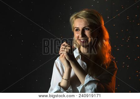 Nice Girl In The White Shirt And Water Drops Behind And Arround Her Illuminated By Light During A Ph