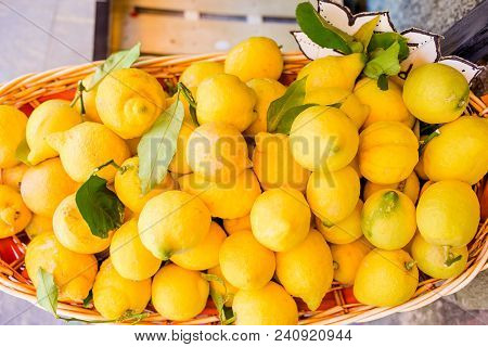 Wicker Basket Full Of Lemons On The Italian Street Od Corniglia In Chinque Terre