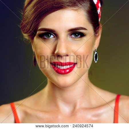 Pin up girl happy and smiling at party. Pin-up retro female style. Girl style wearing red dress. How to properly make up lips. Photo with red color lips accent. Portrait of beautiful laughing girl.