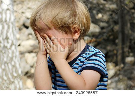 Little Boy Is Playing Hide And Seek