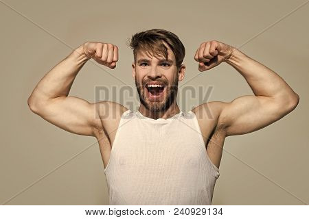 Happy Man Flex Muscles, Biceps, Triceps On Grey Background. Macho With Strong Arms In White Singlet.