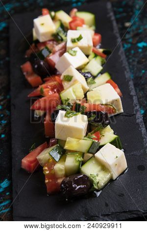 Greek salad with feta cheese cubes and fresk vegetables