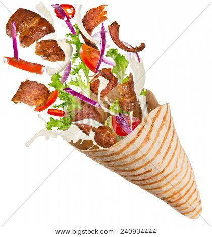 Turkish Kebab yufka with flying ingredients. Freeze motion.