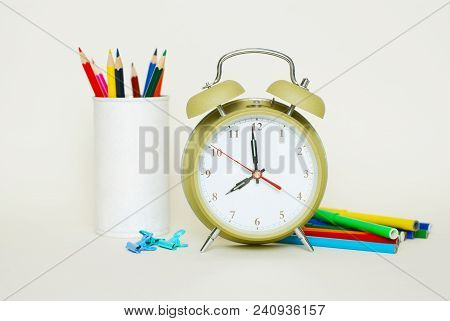 School Suplies. Colored Crayons. Green Clock Isoalted On White