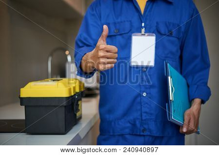 Cropped Image Of Repaiman With Tool Box Showing Thumbs-up