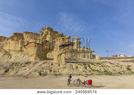 Bicycles Facing The Rocks Resulting From Erosion In Bolnuevo Of Mazarron,  In The Province Of Murcia