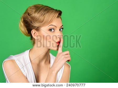 Hush. Charming Woman Having Secret Holds Finger On Lips, Shows Shh Sign. Attractive Woman In White D