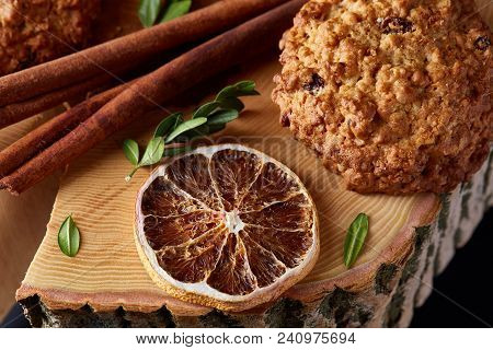 Christmas Concept With Sweet Cookies, Cinnamon Sticks Bunch, A Couple Of Dried Oranges, Anise Star A