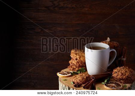 Christmas Concept With A Cup Of Hot Tea, A Large Set Of Cookies, Cinnamon Sticks Bunch, A Couple Of 