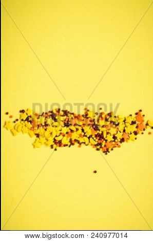 Colorful Nonpareil On Yellow Background. Top View