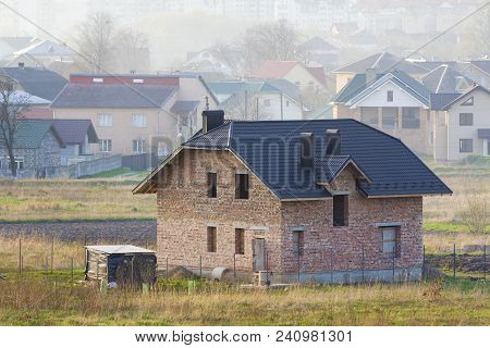 Brand New Spacious Brick Two Story Residential House With Tiling Roof And Windows Openings In Suburb