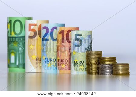 Straight Row Of Accurately Rolled Hundred, Fifty, Twenty, Ten And Five New Paper Euro Banknotes And 