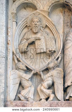 MODENA, ITALY - JUNE 04: Creation Of Adam and Eve, God the Father relief by Wiligelmo, Modena Cathedral, Italy on June 04, 2017.