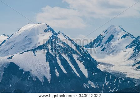 Atmospheric Minimalist Alpine Landscape With Massive Hanging Glacier On Snowy Mountain Peak. Big Bal