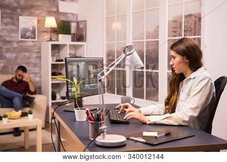 Creative Female Videographer Working On A Movie Using Her Home Computer