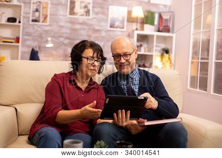 Beautiful Old Couple Using A Digital Tablet To Chat With Their Family