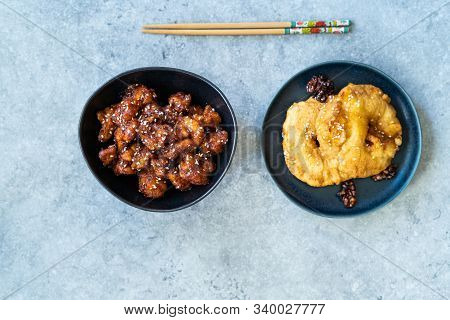 Asian Food Homemade Chinese General Tsos Chicken And Fried Pineapple Fritters Caramelized With Cinna
