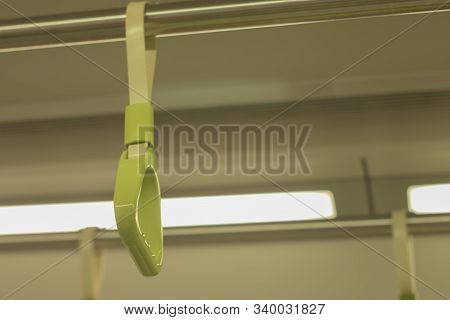 Green Handle On The Metal Rail For Passengers In The Subway While There Are No Passengers