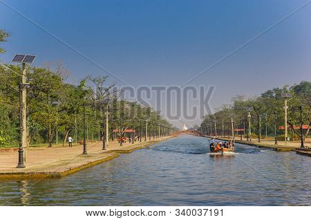Tourists In A Motorboat On The Canal Of The Mayadevi Temple In Lumbini, Nepal