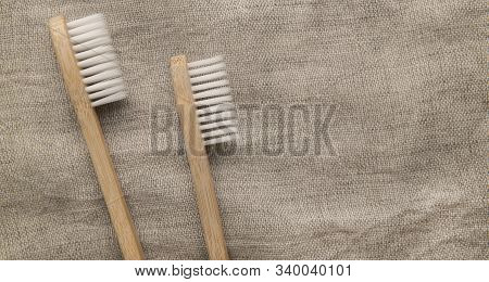 Save The Planet Or No Plastic Concept. Two Eco Bamboo Toothbrushes On Natural Fief Background, Panor