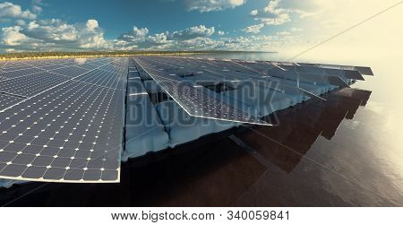 Floating Solar Power Plant Fam On Calm Lake  In Late Afternoon Time With Beautiful Forest Landscape 