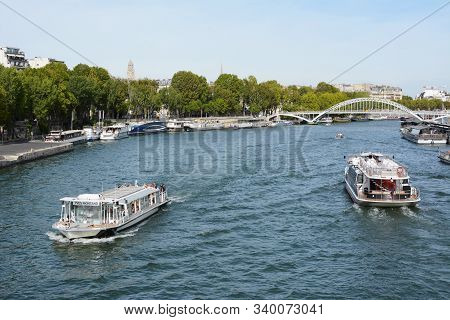 Paris, France - September 16, 2019: Tourist Boat And Batobus Ferry Sail The Seine River, Near The De