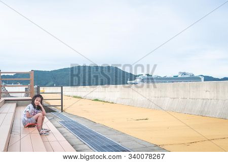 Little Girl Taking Picture With Diamond Princess Cruise On Toba Island, Japan.