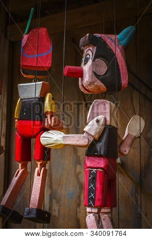 Pinocchio Wooden Puppet Hanging Outside As Decoration