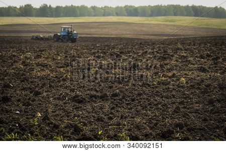 Tractors Plow Plowland On An Autumn Clear Day
