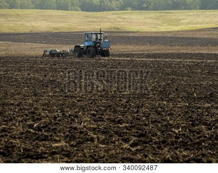 Tractors Plow Plowland On An Autumn Clear Day
