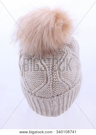 Beige Wool Knit Ski Hat With Faux Fur Pompom Isolated On White. Bobble Hat Topped With Pom Pom Or Lo