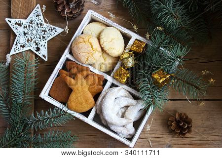 Assorted Christmas Cookies And Christmas Decorations In A Wooden Box On A Wooden Background. Rustic 