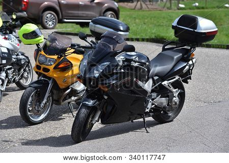 Bad Wildbad, Germany - April 22, 2019: Two Motorcycles, Black And Orange, Honda And Bmw With Luggage
