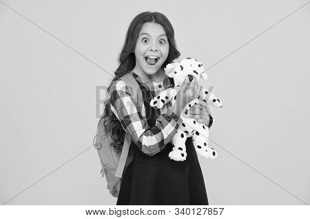 Cuddly Friend. Happy Little Child Hold Toy Dog Yellow Background. Small Girl Smile With Soft Toy Fri