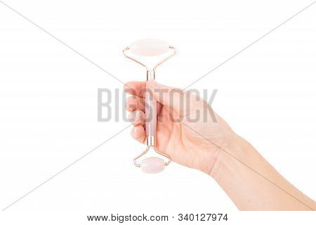 Woman's Hand Holding Jade Roller. Jade Face Roller For Beauty Facial Massage Therapy