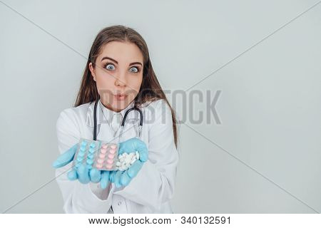 Closeup Portrait Of Young Female Intern Showing Her Palms Full Of Different Pills, Looking Crazily, 