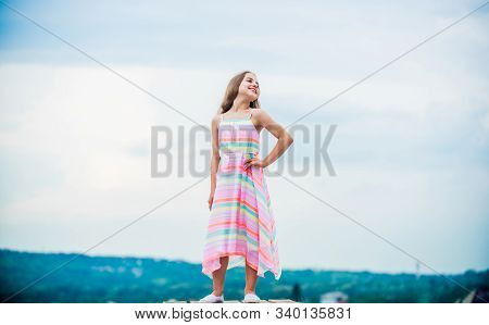 Good Mood At Any Weather. Carefree Child In Summer Dress. Small Girl With Long Curly Hair. Childhood