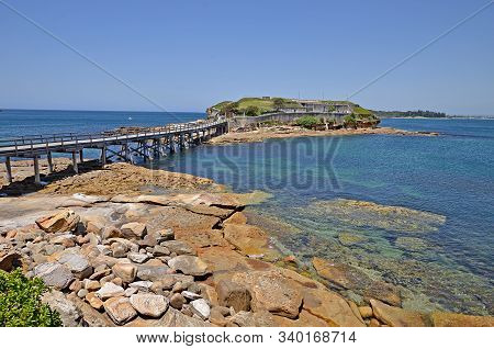 Famous Bare Island And Its Wooden Footbridge In Sunset Light, Sydney Australia. It Is A Former Milit
