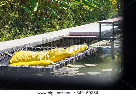 Yellow Cushions For Outdoor Relaxation By The Pool In The Backyard.