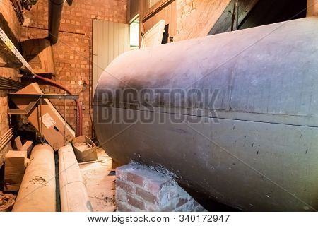 In A Separate Room In A Old Building, There Is A Heating Oil Tank
