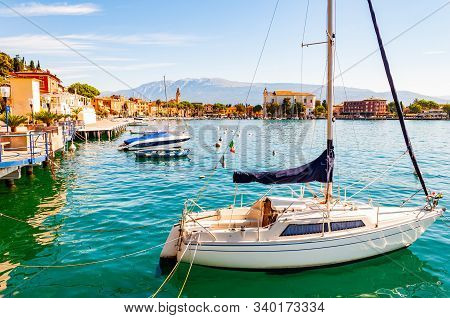 Toscolano Maderno, Lombardy, Italy - September 12, 2019: View On Sailing Yacht And Boats Parked On C