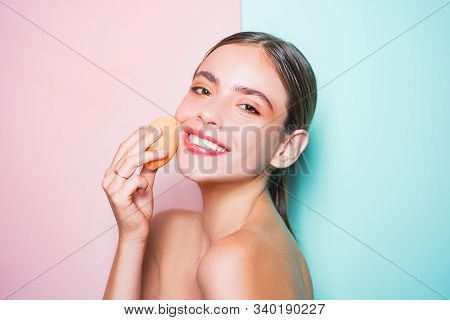 Healthy Smiling Girl With Bare Shoulders, Clear Skin, Dark Hair And Beige Sponge. Natural Makeup Loo