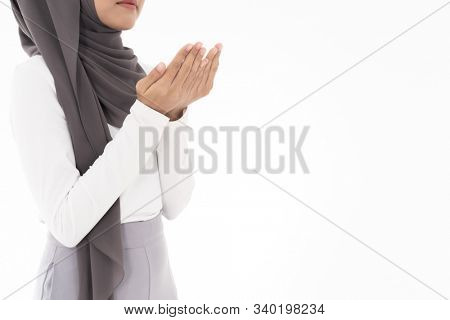 Young Adult Muslim Woman girl making Duas for Muslim god blessing prayer. Studio shot of woman isolated on white background