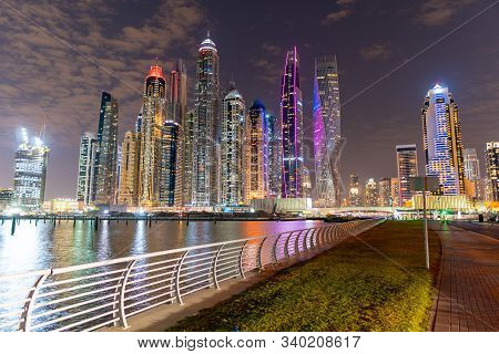 Dubai Skyline At Night With Lights On The Water And Luxirious Skyscrapers Of Uae, Travel Destination