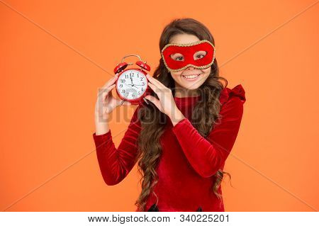 Winter Carnival. Masquerade Concept. Kid Wear Eye Mask. Girl Wear Mask Orange Background. Winter Eve