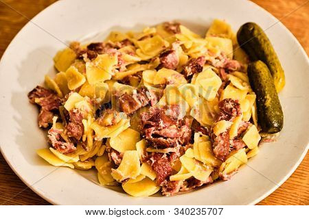 Traditiional Czech Food Sunkofleky - Square Shaped Pasta With Smoked Pork Meat. On White Plate With 