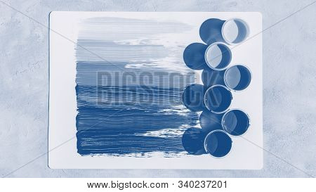 Blue Color Background. Colorful Glass Beads Pattern. Paints In Round Jars And Brush On A Gray Concre