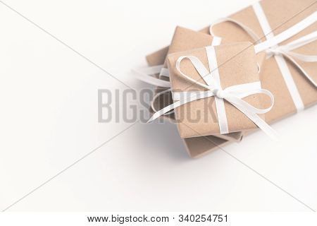 Brown Gift Box Tied With White Ribbon On Clear Background, Copy Space, Eco-friendly Present Concept