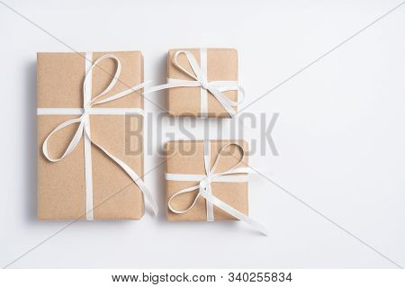 Brown Gift Box Tied With White Ribbon On Clear Background, Copy Space, Eco-friendly Present Concept
