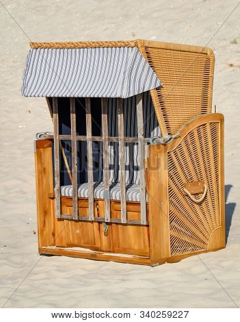 A Locked Beach Chair Stands Lonely On The Beach Of The Baltic Sea